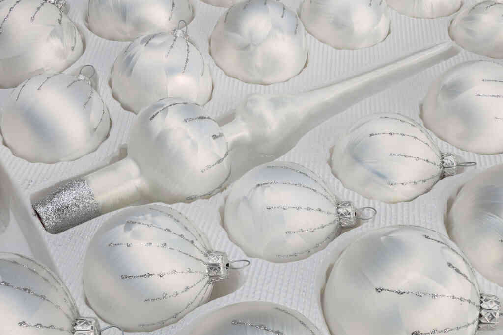 A detailed look on the set of 39 handmade christmas ornaments in "white with silver drops".
